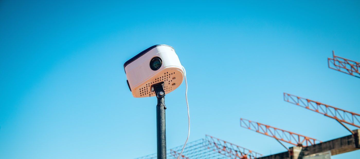 Close view of the printed camera head against a clear sky, one lens visible in its front face.